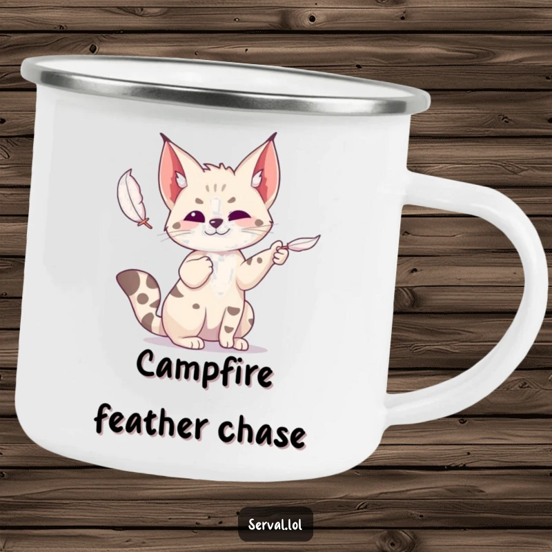 Funny serval camping mug showing a wild cat playfully batting at a feather, designed for outdoor enthusiasts who love fun.