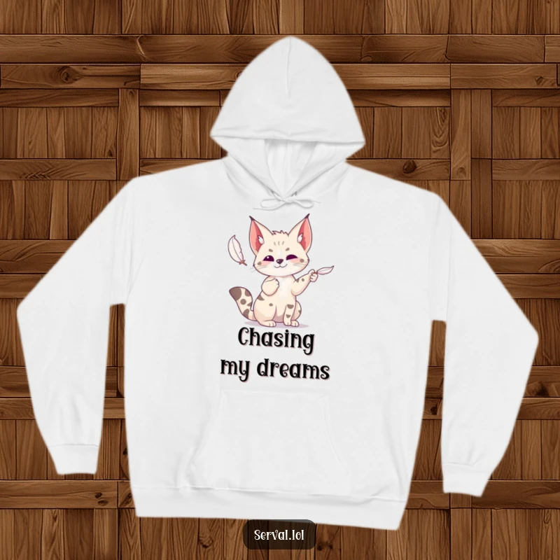 Funny serval hoodie showing a wild cat playfully batting at a feather, capturing a moment of pure, unadulterated fun.