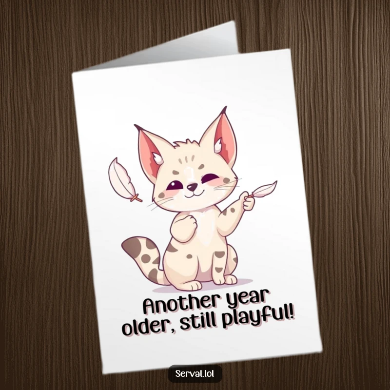 Funny Free Printable Birthday Card: A cute serval gleefully batting at a small, floating feather with playful paws.