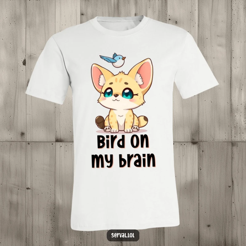 Funny Serval T-Shirt: A small serval gazes up with adoring eyes at a hovering bird, showing sweet fascination.