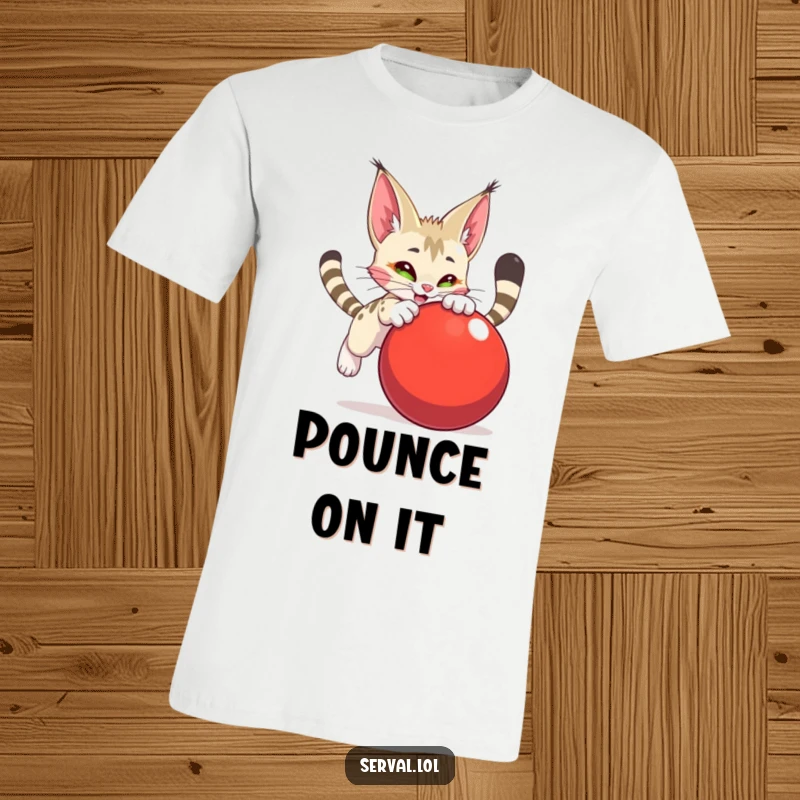 Funny serval character t-shirt, in an exaggerated, playful pounce on a large, bright red ball, exuding boundless energy.